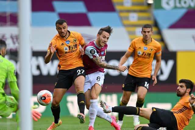 Josh Brownhill's shot is blocked by Ruben Neves