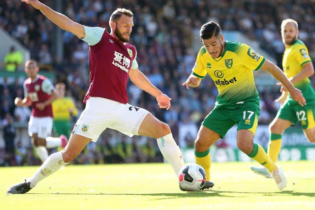 Emiliano Buendia of Norwich City is challenged by Erik Pieters of Burnley during the Premier League match between Burnley FC and Norwich City at Turf Moor on September 21, 2019 in Burnley, United Kingdom. (Photo by Alex Morton/Getty Images)