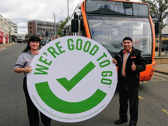 Debbie Barton (left) and Uma Ali from The Burnley Bus Company celebrate the award of a tourism tick confidence mark to the bus firm by tourism agency VisitEngland