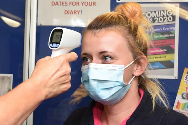 Phillipa Astley has her temperature checked on arrival
