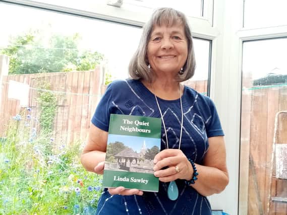 Linda Sawley pictured with her book written during lockdown, The Quiet Neighbours