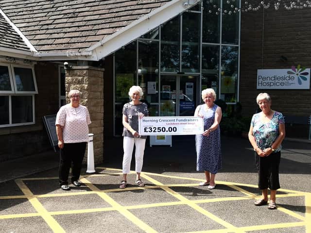 Horning Crescent residents present a cheque to Pendleside Hospice
