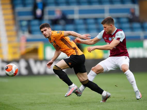 Ruben Vinagre of Wolverhampton Wanderers battles for possession with Johann Berg Gudmundsson of Burnley during the Premier League match between Burnley FC and Wolverhampton Wanderers at Turf Moor on July 15, 2020 in Burnley, England. (Photo by Clive Brunskill/Getty Images)