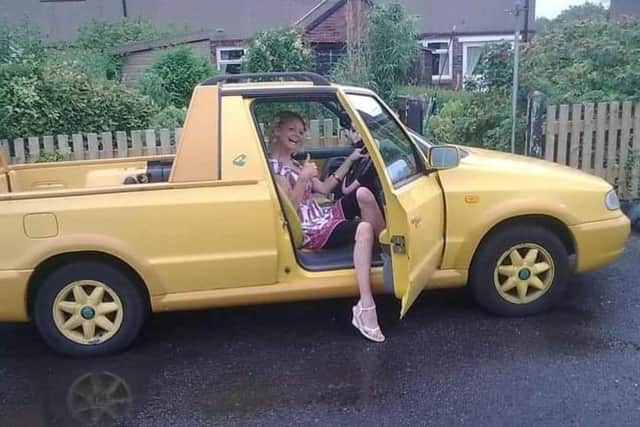 Nikki Sawley behind the wheel of the car that was as bright and eye catching as her, a Skoda Felicia Fun Box