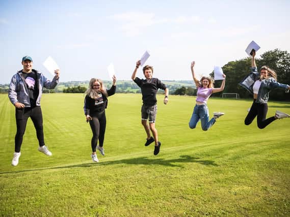 Jake Perry, Kathryn Byrne, Josh Dodding, Elsie-Mae Pickup and Charlotte Heys jump for joy at Westholme School.