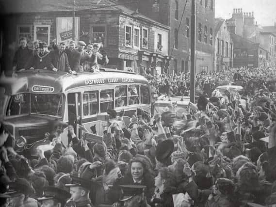 The Burnley FC team coach makes its way through the crowds just below the Finsley Gate junction with Manchester Road