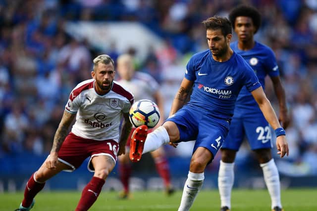 Cesc Fabregas of Chelsea controls the ball while under pressure from Steven Defour of Burnley during the Premier League match between Chelsea and Burnley at Stamford Bridge on August 12, 2017 in London, England. (Photo by Dan Mullan/Getty Images)