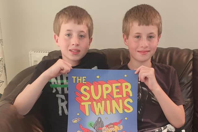 Luke and Liam with their dad's book