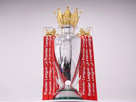 The Premier League Trophy is dressed in Liverpool Red Ribbons.