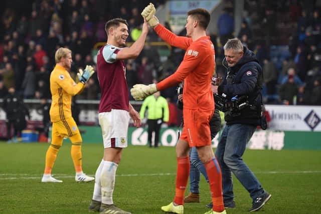 Burnley's English goalkeeper Nick Pope celebrates with defender James Tarkowski after the English Premier League football match between Burnley and Leicester City at Turf Moor(Photo by Oli SCARFF/AFP)