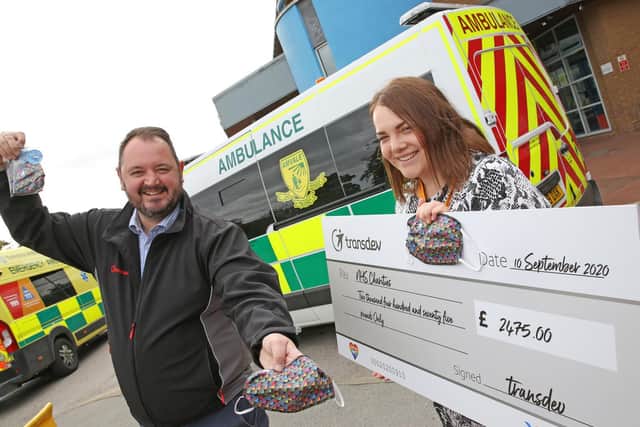 Transdev CEO Alex Hornby hands over a cheque for £2,475, the first wave of proceeds from sales of the bus firm’s ‘All the Colours of Transdev’ designer face coverings, to Harrogate District Hospital’s Community and Events Fundraiser Georgia Hudson, representing NHS Charities Together, who support NHS staff and volunteers caring for COVID-19 patients nationwide.