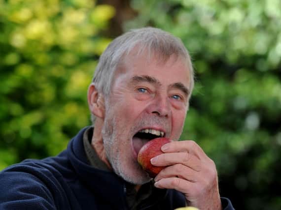 Happy harvest: Phil Rainford pictured tasting an apple