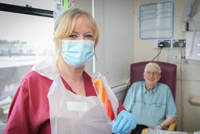 Ribblesdale Ward house-keeper Christine Ryan offers patient
Raymond Dunkerley an ice lolly while on her regular ice lolly round that
Rosemere Cancer Foundation will continue to fund for the rest of this year and
next