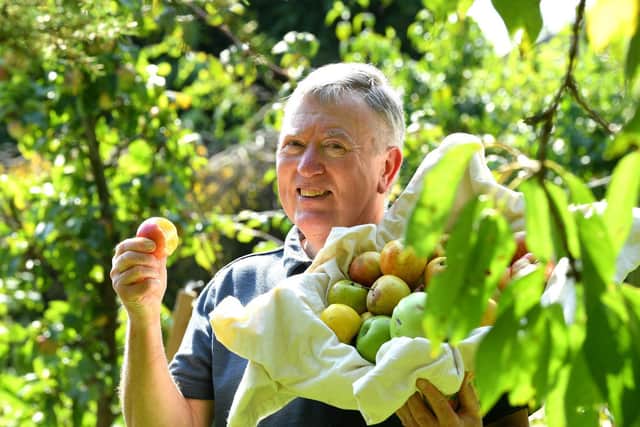 Martin Charlesworth savours this year's  homegrown apple harvest 
Photo: Neil Cross