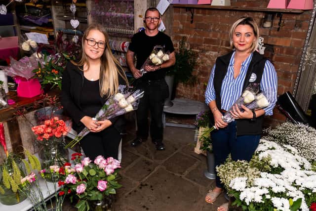 Jennifer (right) Kerry and James prepare more roses for delivery as part of the 'Roses for Heroes' initiative