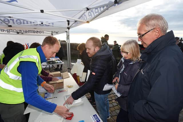 Rosemere Cancer Foundation chief officer Dan Hill (left) registers
walkers at the sign-in to last year’s fundraising Walk the Lights. Now he wants
day-trippers to take the same Promenade route through the Illuminations but
in their own family bubble