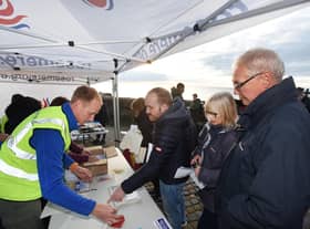 Rosemere Cancer Foundation chief officer Dan Hill (left) registers
walkers at the sign-in to last year’s fundraising Walk the Lights. Now he wants
day-trippers to take the same Promenade route through the Illuminations but
in their own family bubble
