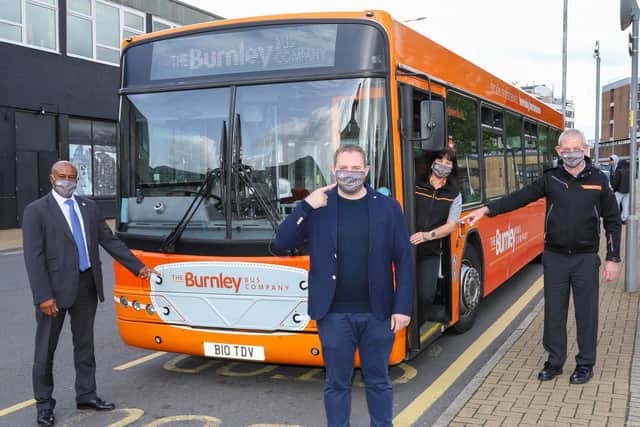 Burnley MP Antony Higginbotham (centre) joins staff from The Burnley Bus Company to remind customers that unless they are legally exempt, wearing a face covering is mandatory on all bus journeys