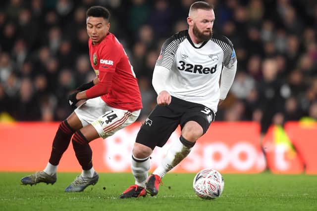 Wayne Rooney of Derby County and Jesse Lingard of Manchester United during the FA Cup Fifth Round match between Derby County and Manchester United at Pride Park on March 05, 2020 in Derby, England.