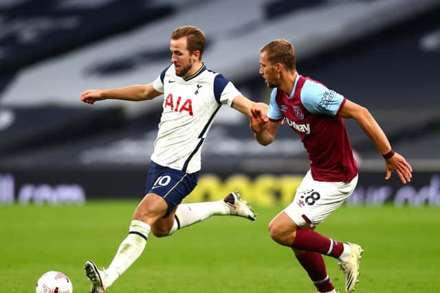 Harry Kane of Tottenham Hotspur is challenged by Tomas Soucek of West Ham United during the Premier League match between Tottenham Hotspur and West Ham United at Tottenham Hotspur Stadium on October 18, 2020 in London, England.