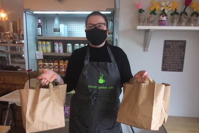 Generous staff from the Secret Garden Cafe prepare food bags to feed needy kids during half term