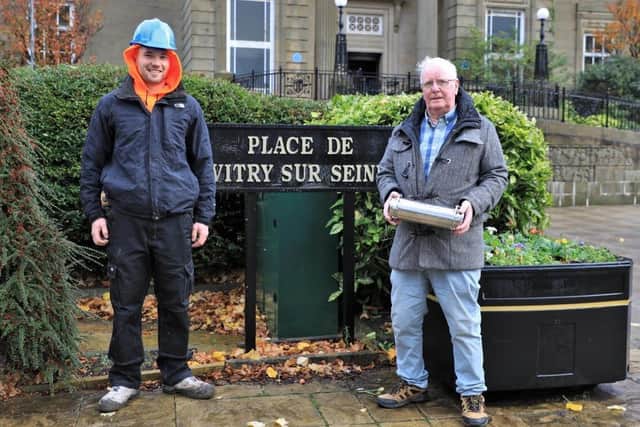 Jack Nadin (right) holding a time capsule which will be placed inside the memorial itself with stonemason Chris Sharp, who will be undertaking the building work.