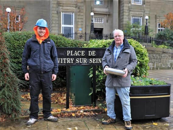 Jack Nadin (right) holding a time capsule which will be placed inside the memorial itself with stonemason Chris Sharp, who will be undertaking the building work.