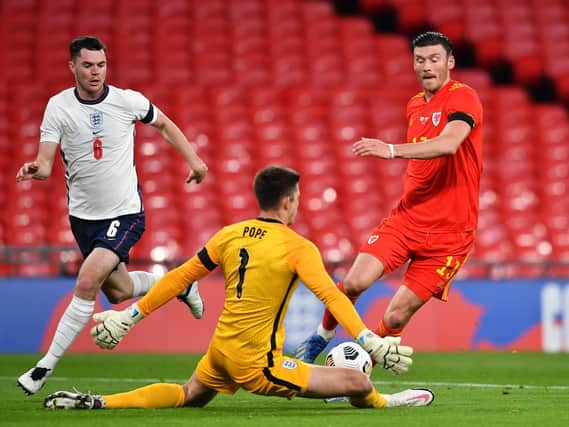 Kieffer Moore of Wales collides with Nick Pope of England as Michael Keane of England looks on during the international friendly match between England and Wales at Wembley Stadium on October 08, 2020 in London, England.