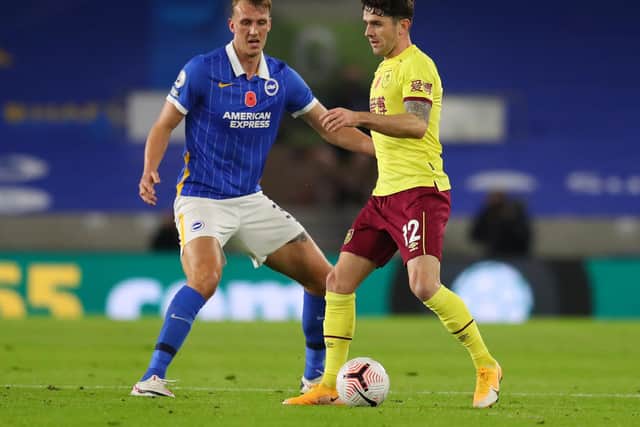 Robbie Brady of Burnley is challenged by Dan Burn of Brighton and Hove Albion during the Premier League match between Brighton & Hove Albion and Burnley at American Express Community Stadium on November 06, 2020 in Brighton, England.