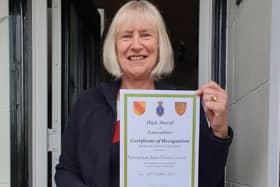 Coun. Pat Osbaldeston with the certificate of recognition from the High Sheriff of Lancashire.