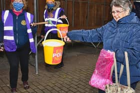 Clitheroe resident, Barbara Sanderson, making a donation to a socially distanced, bucket on a pole.