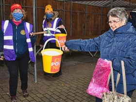 Clitheroe resident, Barbara Sanderson, making a donation to a socially distanced, bucket on a pole.