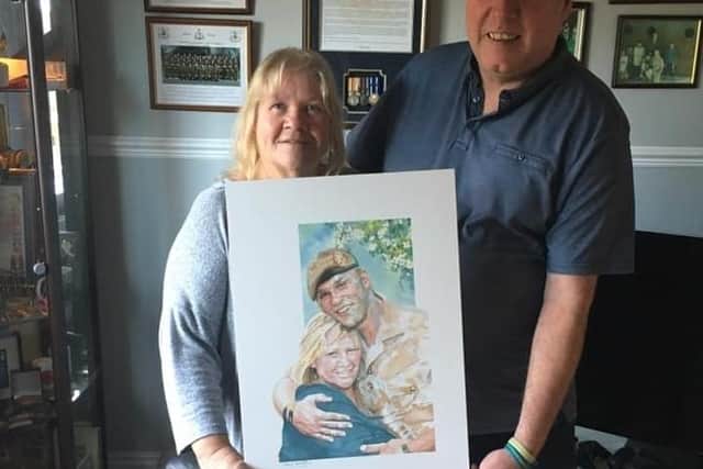 Tony and Sheila Bancroft with the portrait Andrew Powell commissioned as a tribute for their son Jordan.