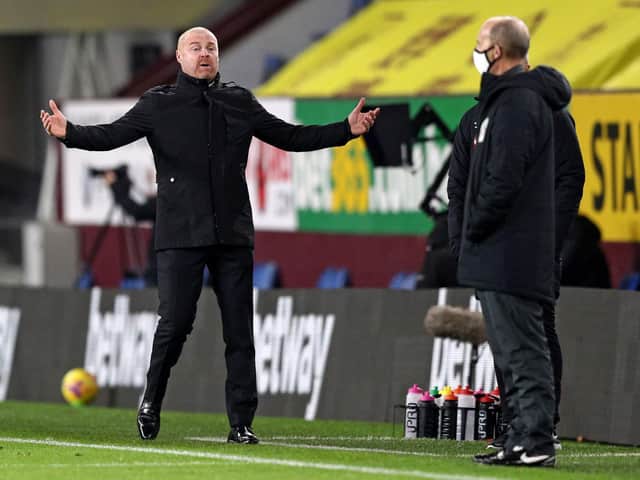 Burnley's English manager Sean Dyche (L) gestures to fourth official Mike Dean (R) during the English Premier League football match between Burnley and Crystal Palace at Turf Moor in Burnley, north west England on November 23, 2020.