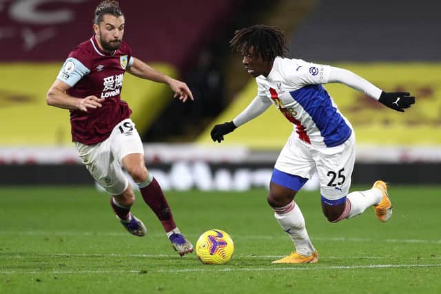 Eberechi Eze of Crystal Palace is challenged by runs away from Jay Rodriguez of Burnley during the Premier League match between Burnley and Crystal Palace at Turf Moor on November 23, 2020 in Burnley, England.