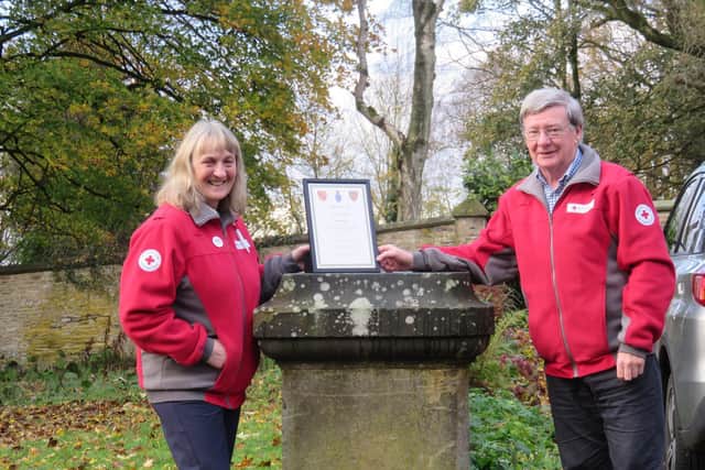Sue receives her award from Gordon Low, the President of Lancashire British Red Cross