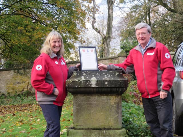 Sue receives her award from Gordon Low, the President of Lancashire British Red Cross