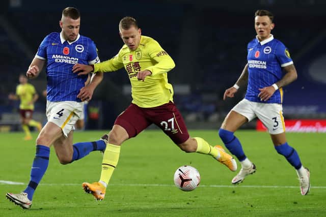 Brighton's English defender Adam Webster (L) chases back as Burnley's Czech striker Matej Vydra (C) runs at goal during the English Premier League football match between Brighton and Hove Albion and Burnley at the American Express Community Stadium in Brighton, southern England on November 6, 2020.