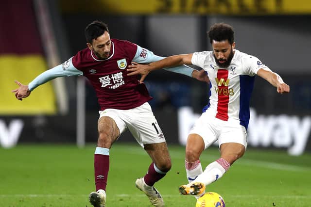Andros Townsend of Crystal Palace is challenged by Dwight McNeil of Burnley during the Premier League match between Burnley and Crystal Palace at Turf Moor on November 23, 2020 in Burnley, England.