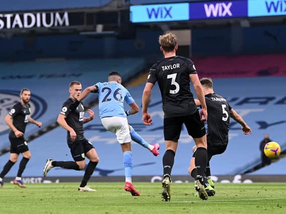 Riyad Mahrez of Manchester City scores his team's second goal during the Premier League match between Manchester City and Burnley at Etihad Stadium on November 28, 2020 in Manchester, England.