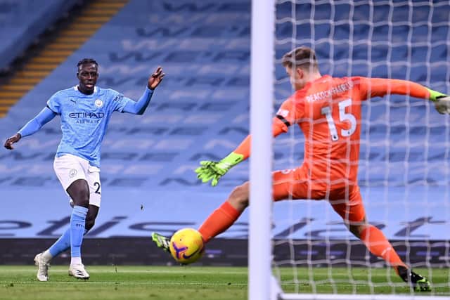 Benjamin Mendy of Manchester City scores their team's third goal past Bailey Peacock-Farrell of Burnley during the Premier League match between Manchester City and Burnley at Etihad Stadium on November 28, 2020 in Manchester, England.