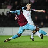 Luke Chadwick of MK Dons is challenged by Andre Bikey of Burnley during the FA Cup 3rd Round match between MK Dons and Burnley at Stadiummk on January 2, 2010 in Milton Keynes, England.