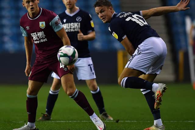 Burnley's English midfielder Josh Benson (L) vies with Millwall's English striker Matt Smith during the English League Cup third round football match between Millwall and Burnley at The Den in south London, on September 23, 2020.