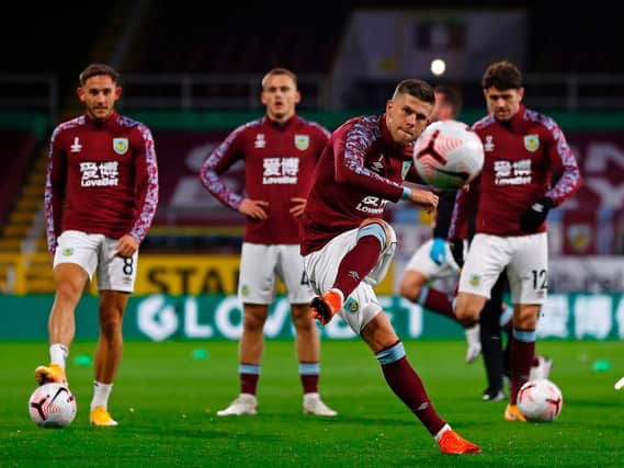 Burnley's Icelandic midfielder Johann Berg Gudmundsson (C) and teammates warm up ahead of the English Premier League football match between Burnley and Tottenham Hotspur at Turf Moor in Burnley, north west England on October 26, 2020.