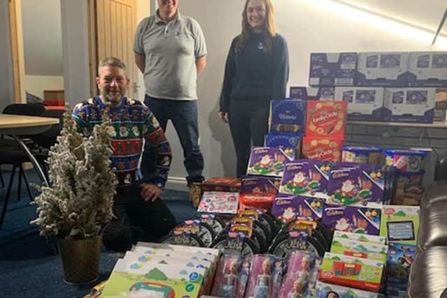 JCS Interiors staff (left to right) who are estimating director Paul Sterry, managing director Dave Allen and office manager Bryony Green, with their haul of Christmas goodies for the toy appeal.