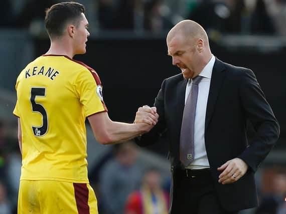 Burnley manager Sean Dyche congratulates Burnley's English defender Michael Keane after the English Premier League football match between Crystal Palace and Burnley at Selhurst Park on April 29, 2017. Burnley won the game 2-0.