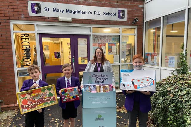 Teacher Mrs Kelly Barnes with pupils at St Mary Magdalene's and the gifts they collected for the Christmas Toy Appeal.