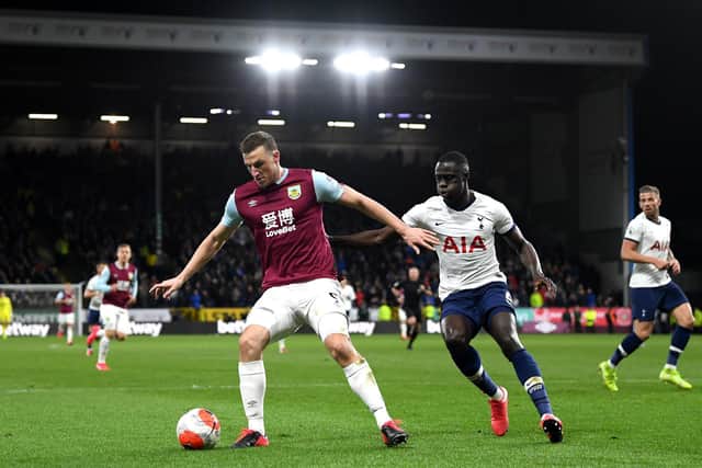 Chris Wood of Burnley controls the ball with pressure from during the Premier League match between Burnley FC and Tottenham Hotspur at Turf Moor on March 07, 2020 in Burnley, United Kingdom.