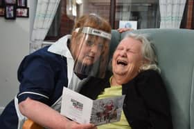 Louise Newton, left, with Ann Trowbridge and a Christmas card at the Brookside Care Home on December 1, 2020 (Picture: Neil Cross for JPIMedia)