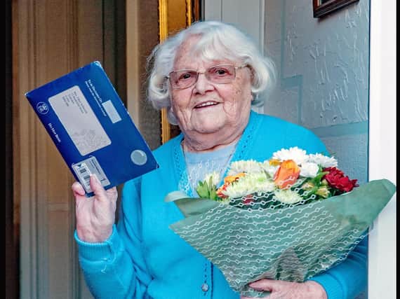 Ethel Ashworth with her telegram from the Queen, and the flowers given to her on behalf of Trawden Forest Friendship Group